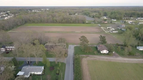 Flying over farm land while panning up to a waxing Moon over the horizon. Stock Footage 153034663