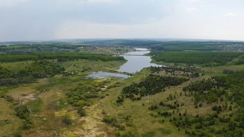 Flying over a field and forest Stock Footage 108118690