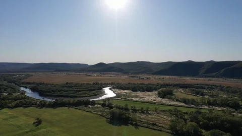 Flying over the field and river Stock Footage