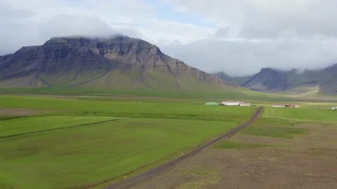 Flying over a field and road in an epic scenery in west Iceland Stock Footage 138709496