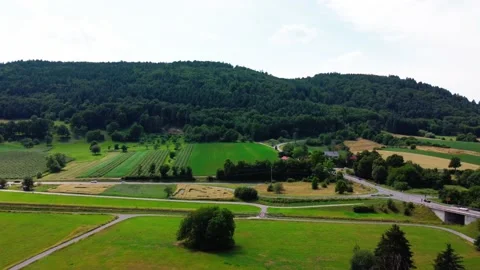 Flying over the field and the road with cars Stock Footage 161066594