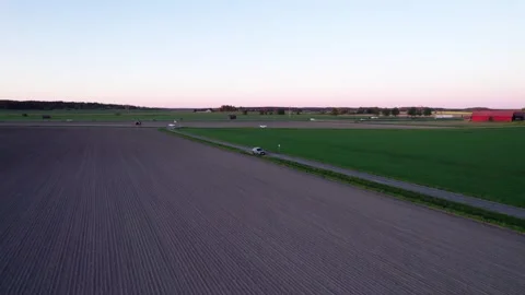 Flying over the field to the road Stock Footage 276530349