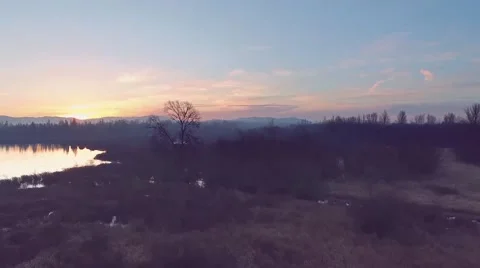 Flying over the fields and forests at sunset sunrise. Aerial 4k Stock-Footage 52531672