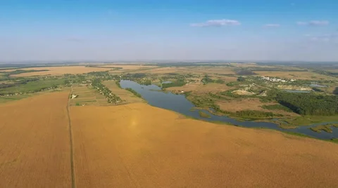Flying Over Fields and River Stock Footage 68346087