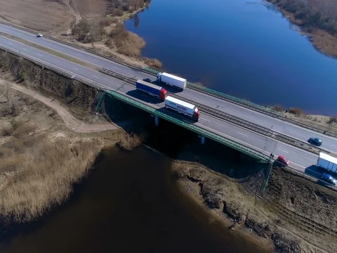 Flying over the fields and road transport logistics Stock Footage