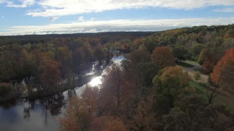 Flying over Flat river and fall colors in 4K, Michigan Stock Footage 56335626
