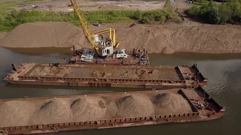 Flying over floating crane and sand barge near river coast, 4k Video stock 78537693