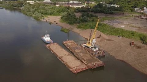 Flying over floating crane and sand barge near river coast, 4k Stock Footage 78537990