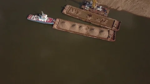 Flying over floating crane and sand barge near river coast, 4k Stock Footage 78538081