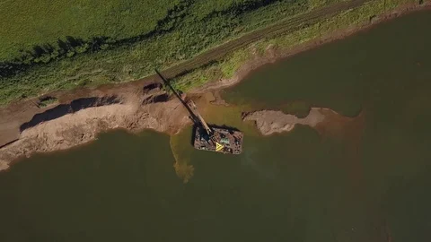 Flying over floating crane near river coast, 4k Stock Footage 78376587