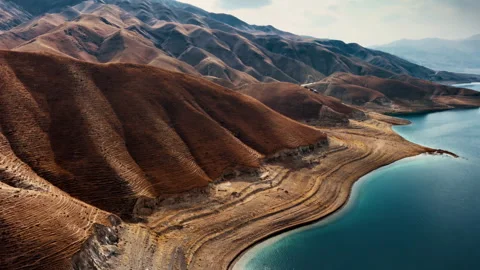 Flying over a flooded quarry among the mountains Stock Footage 297087790