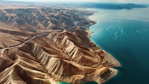 Flying over a flooded quarry among the mountains Stock Footage 297087792