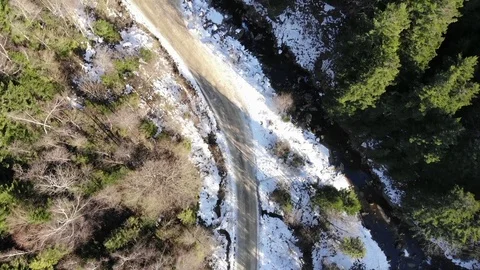 Flying over the forest and road at winter  near the river Stock Footage 124407446