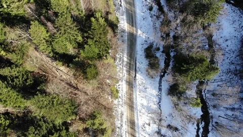 Flying over the forest and road at winter  near the river Stock Footage 124407928