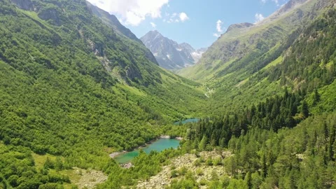 Flying over a forest and two lakes with turquoise water among the mountains in Stock Footage 269301378