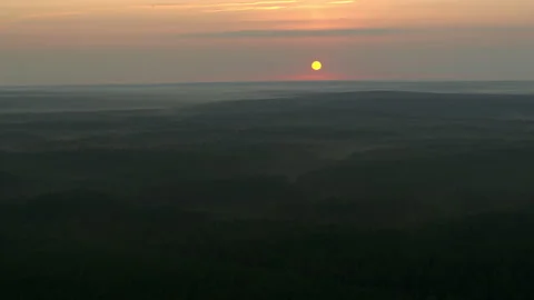 Flying over the forest and a view of the sunrise Stock Footage 177997714