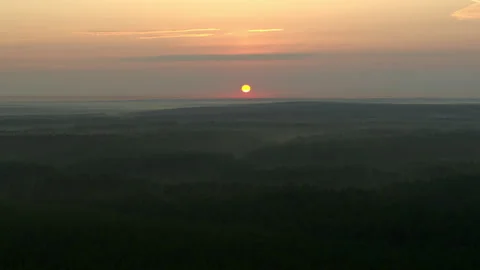 Flying over the forest and a view of the sunrise Stock Footage 194384008