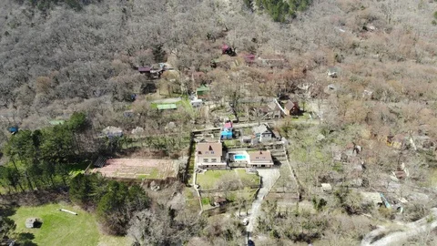 Flying over the forest. Flying over a mountain village. Stock Footage 124756223