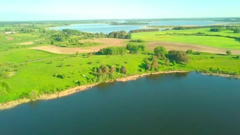 Flying over forest lake. picturesque place, large lake surrounded by forest Stock Footage 155746292