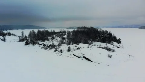 Flying over frozen sea, aerial fjord covered with ice and snow Stock Footage