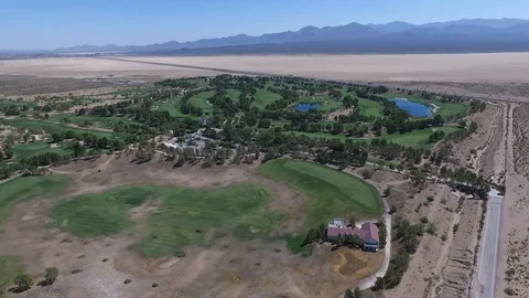 Flying over golf course in desert Stock Footage 88568658