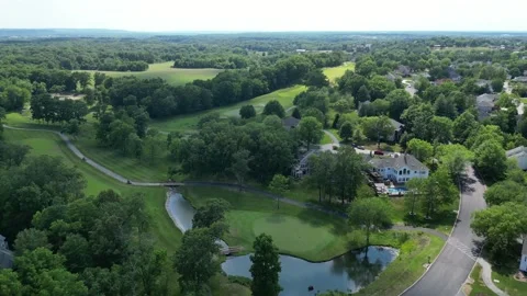 Flying over golf course in the suburbs, aerial drone Stock Footage 245104071