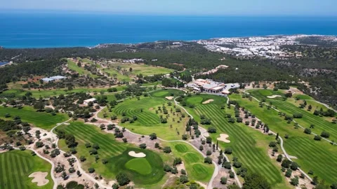 Flying over golf courses. Golf on holiday. Expensive green golf courses. Sea. Stock Footage 276294813