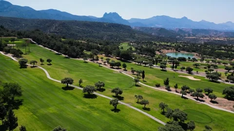 Flying over golf courses. Golf on holiday. Expensive green golf courses. Sea. Stock Footage 276294878