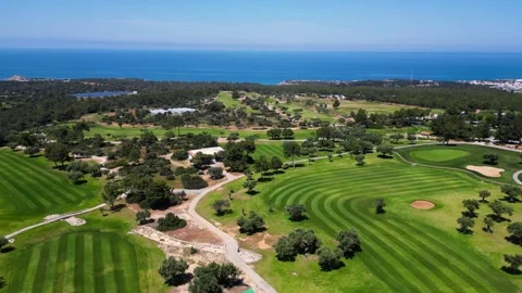 Flying over golf courses. Golf on holiday. Expensive green golf courses. Sea. Stock Footage 276295393