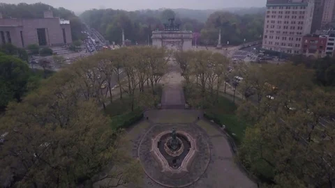 Flying over Grand Army Plaza towards Prospect Park in Brooklyn Stock Footage