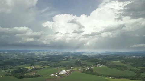 Flying over green fields and road with great clouds ahead. Stock Footage 234455857
