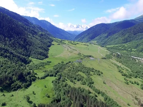 Flying over green fields meadows of Mountain Valley Aerial 4k video Stock Footage 80314475