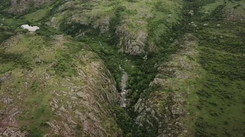 Flying over the green hilly area. Drone video Stock Footage 208312571