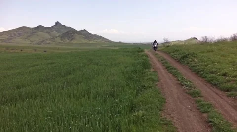 Flying over the green landscape and motorcycles Stock Footage 50528687