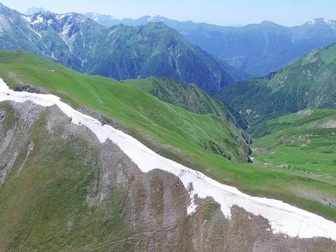 Flying over group hikers tourists moving on mountain range Aerial 4k video Stock Footage 80314554
