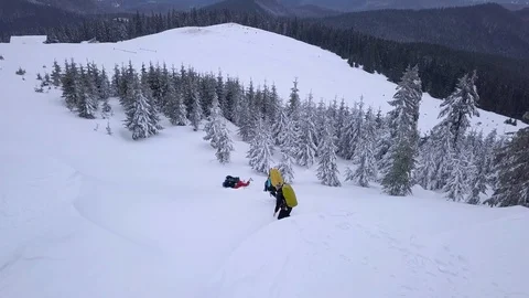 Flying over a group of tourists in the winter mountains Stock Footage 104842801