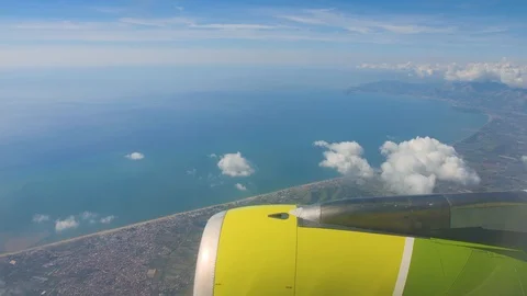 Flying over Gulf of Naples. View on blue sea and city on a shore from airplane 库存影片 99001987