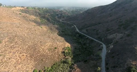 Flying over Hall Canyon behind the foothills of Ventura, California Stock Footage 73099403