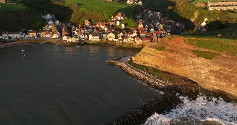 Flying over a harbbor in Staithes Stock Footage 248015741
