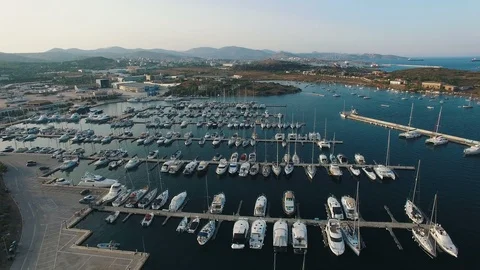 Flying over harbor with yachts, sailing boats and catamarans in the evening Stock Footage 87082466