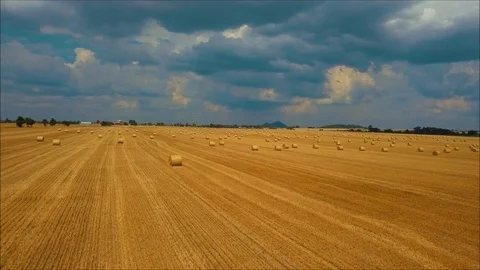 Flying over haystacks on the background of mountain landscape Video stock 108650528