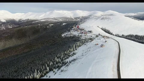 Flying over a high mountain road towards the peaks during winter time Stock Footage 234205982