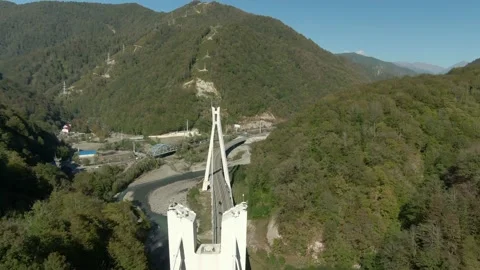 Flying over a high-speed highway in a mountain gorge above a stormy river Video stock 141609641