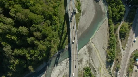 Flying over a high-speed highway in a mountain gorge above a stormy river Video stock 141609686