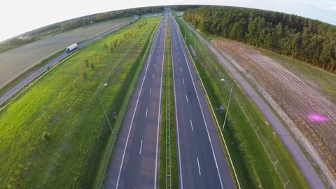 Flying over a highway in green fields Video stock 80195587