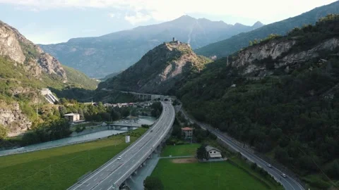 Flying over highway with traffic in mountain region slow motion. Drone Stock Footage 158683441