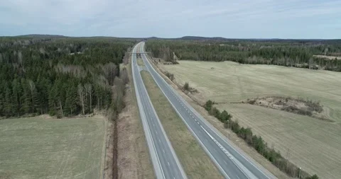 Flying over a highway with two oncoming lanes. Stock Footage 131060349