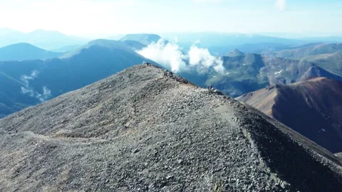 Flying over hikers at the summit of Torreys Peak in Colorado Stock Footage 247363810
