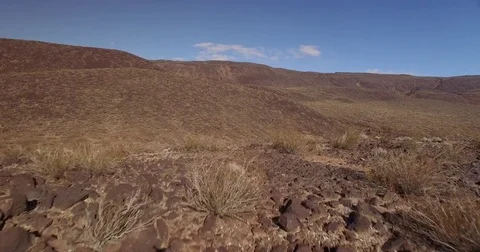 Flying over a hill in the desert Stock Footage 81049243