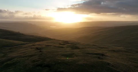 Flying over the hills and valley in north Yorkshire at sunrise Stock Footage 219948833